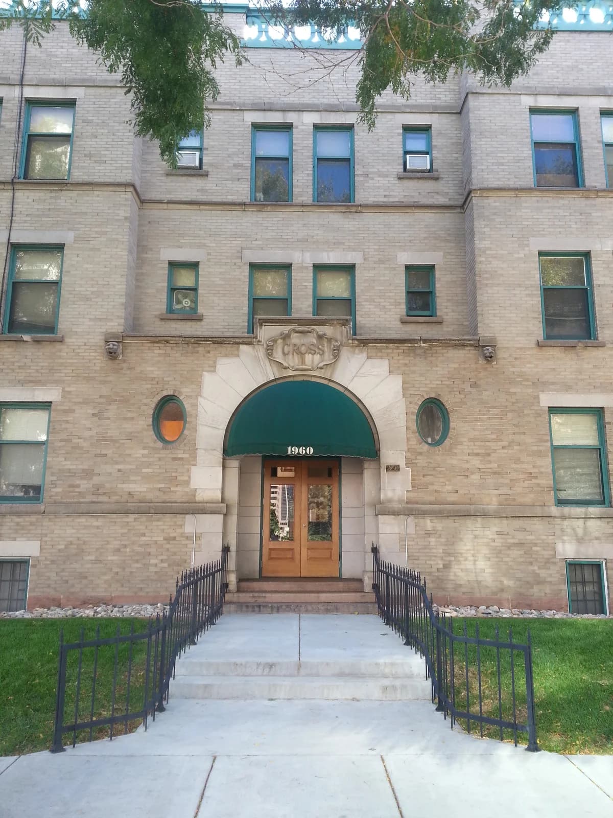 Milwaukee apartments for rent - image - Historic brick apartment facade with green awnings and well-maintained entrance.