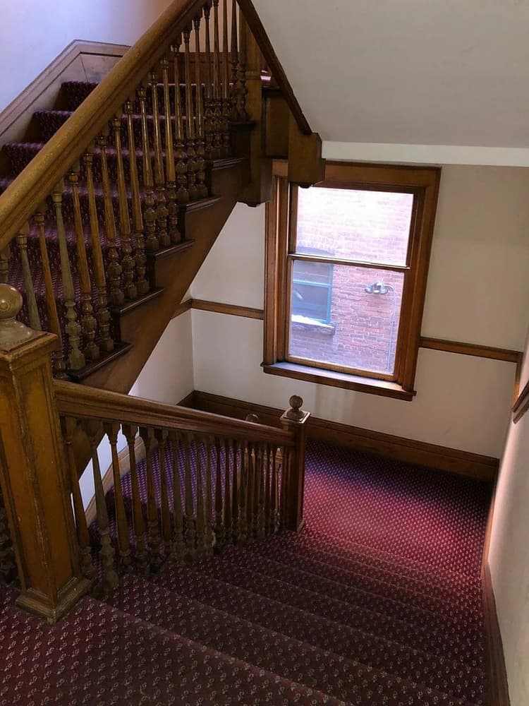 Milwaukee apartments for rent - image - Step into elegance with this beautifully crafted wooden staircase, perfect for a warm and inviting home atmosphere.